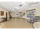Bright community room with tiled floor and seating at 1730 Manasota Beach Rd # 110, Englewood, FL 34223