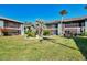 Lush green courtyard with tropical landscaping at 1730 Manasota Beach Rd # 110, Englewood, FL 34223