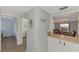 View of dining area with chandelier, and access to kitchen at 1730 Manasota Beach Rd # 110, Englewood, FL 34223