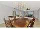 Spacious dining area featuring a wood table and chandelier at 1730 Manasota Beach Rd # 110, Englewood, FL 34223