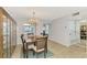 Bright dining room with chandelier and hardwood floors at 1730 Manasota Beach Rd # 110, Englewood, FL 34223