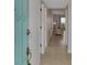 Bright entryway with teal door and view into living room at 1730 Manasota Beach Rd # 110, Englewood, FL 34223