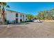 Building exterior with parking and landscaping at 1730 Manasota Beach Rd # 110, Englewood, FL 34223