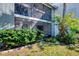 Ground level view of condo building and landscaping at 1730 Manasota Beach Rd # 110, Englewood, FL 34223