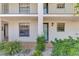 Inviting condo exterior featuring a well-maintained facade, manicured landscaping, and a private entrance at 1730 Manasota Beach Rd # 110, Englewood, FL 34223