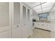 White kitchen with built-in microwave and ample storage at 1730 Manasota Beach Rd # 110, Englewood, FL 34223