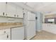 White appliances and cabinetry in this galley-style kitchen at 1730 Manasota Beach Rd # 110, Englewood, FL 34223