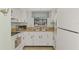 Efficient kitchen with white cabinets and appliances at 1730 Manasota Beach Rd # 110, Englewood, FL 34223