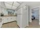 Kitchen with white cabinets and tile floor at 1730 Manasota Beach Rd # 110, Englewood, FL 34223