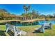Serene pond with two park benches and lush greenery at 1730 Manasota Beach Rd # 110, Englewood, FL 34223