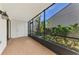Private screened porch with brick tile flooring at 1730 Manasota Beach Rd # 110, Englewood, FL 34223