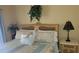 Bedroom with a queen-size bed and tropical decor at 1760 Gulf Blvd # 511, Englewood, FL 34223