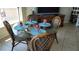 Bright dining area with glass table and four chairs, perfect for casual meals at 1760 Gulf Blvd # 511, Englewood, FL 34223
