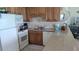 Well-equipped kitchen with light wood cabinets and granite counters at 1760 Gulf Blvd # 511, Englewood, FL 34223