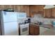 White appliances and wood cabinets in this galley kitchen at 1760 Gulf Blvd # 511, Englewood, FL 34223