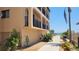 Side of condo building with walkway leading to pool and beach access at 1760 Gulf Blvd # 511, Englewood, FL 34223