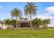 Spacious backyard with lush landscaping and home view at 185 Rotonda E Blvd, Rotonda West, FL 33947