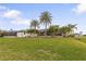 Large backyard with beautiful landscaping and home view at 185 Rotonda E Blvd, Rotonda West, FL 33947