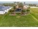 Elevated backyard view showcasing a spacious lawn, pool, and tropical landscaping at 185 Rotonda E Blvd, Rotonda West, FL 33947