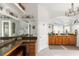 Bathroom with granite double vanity and large mirrors at 185 Rotonda E Blvd, Rotonda West, FL 33947