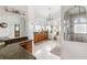 Large bathroom with granite countertops, soaking tub, and walk-in shower at 185 Rotonda E Blvd, Rotonda West, FL 33947
