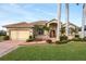 Single-story home features a welcoming porch and lush landscaping at 185 Rotonda E Blvd, Rotonda West, FL 33947