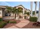 Relaxing front porch with rocking chairs and palm trees at 185 Rotonda E Blvd, Rotonda West, FL 33947