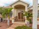 Inviting front porch with two rocking chairs, framed by lush landscaping and palm trees at 185 Rotonda E Blvd, Rotonda West, FL 33947