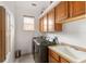 Laundry room with washer, dryer, cabinets and utility sink at 185 Rotonda E Blvd, Rotonda West, FL 33947
