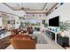 Spacious living room with leather furniture and a large TV at 185 Rotonda E Blvd, Rotonda West, FL 33947
