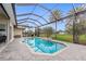Inviting pool area with covered patio, lush landscaping, and outdoor kitchen at 185 Rotonda E Blvd, Rotonda West, FL 33947