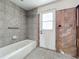 Bathroom with tiled walls and a tub at 1924 Mississippi Ave, Englewood, FL 34224