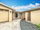Inviting entryway with a paved walkway, attached garage, and landscaping at 1924 Mississippi Ave, Englewood, FL 34224
