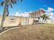 Landscaped front yard with gate, next to a home under construction at 1924 Mississippi Ave, Englewood, FL 34224