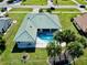 Aerial view showing home, pool, and landscaping at 19782 Midway Blvd, Port Charlotte, FL 33948