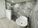 Modern bathroom with walk-in shower and pebble floor at 19782 Midway Blvd, Port Charlotte, FL 33948