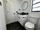Updated bathroom with a white vanity and black granite countertop at 19782 Midway Blvd, Port Charlotte, FL 33948
