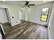 Well-lit bedroom featuring mirrored closet doors and wood-look floors at 19782 Midway Blvd, Port Charlotte, FL 33948