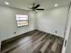 Spacious bedroom with ceiling fan and large window at 19782 Midway Blvd, Port Charlotte, FL 33948