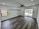 Spacious bedroom with hardwood floors, sliding doors, and pool view at 19782 Midway Blvd, Port Charlotte, FL 33948