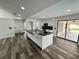 Modern kitchen with white cabinets, granite island, and stainless steel appliances at 19782 Midway Blvd, Port Charlotte, FL 33948