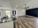 Open living room and kitchen with hardwood floors and high ceilings at 19782 Midway Blvd, Port Charlotte, FL 33948