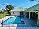 Relaxing rectangular pool with blue tile and fence at 19782 Midway Blvd, Port Charlotte, FL 33948
