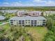 Back view of the building showcasing screened balconies and landscaping at 2121 Heron Lake Dr # 301, Punta Gorda, FL 33983