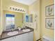 Double vanity bathroom with light yellow walls and a walk-in shower at 2121 Heron Lake Dr # 301, Punta Gorda, FL 33983