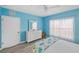 Blue bedroom with white dresser and large window, offering a peaceful vibe at 2121 Heron Lake Dr # 301, Punta Gorda, FL 33983