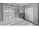 Bedroom with wood-look floors and large windows at 2121 Heron Lake Dr # 301, Punta Gorda, FL 33983