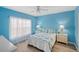 Light blue bedroom with double bed and en-suite bathroom access at 2121 Heron Lake Dr # 301, Punta Gorda, FL 33983