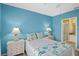 Serene blue bedroom with a double bed and plenty of natural light at 2121 Heron Lake Dr # 301, Punta Gorda, FL 33983