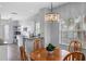 Bright dining area with wood table and chandelier, adjacent to kitchen at 2121 Heron Lake Dr # 301, Punta Gorda, FL 33983